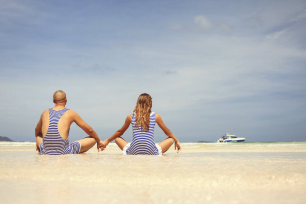 迷人的情侣在沙滩上穿着泳装度假图片下载