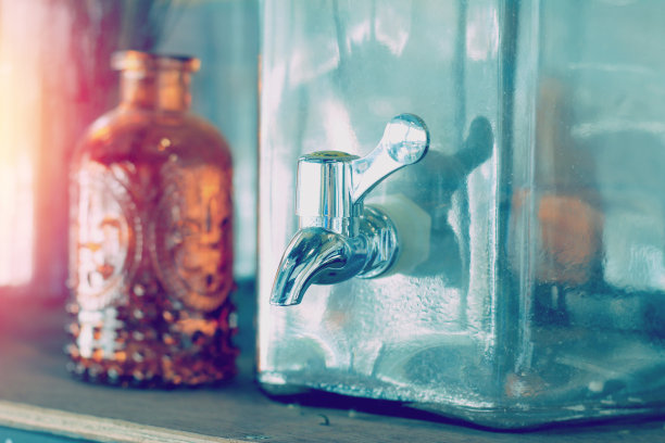 来自咖啡馆的老式玻璃饮水机的水龙头。图片下载