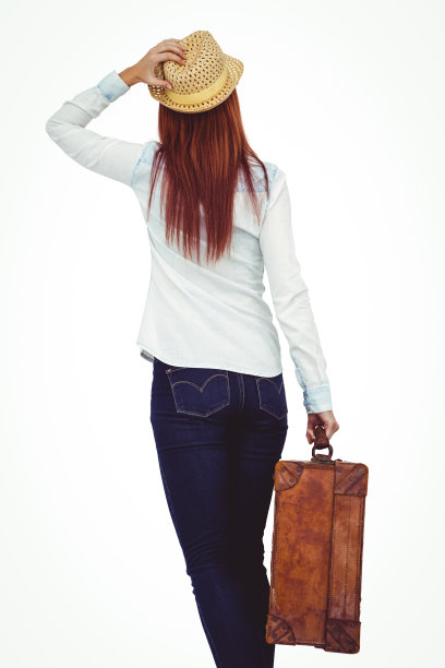 后视图的潮女人拿着手提箱图片下载