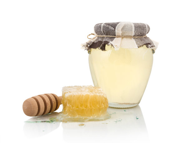 把蜂蜜放在装有蜂窝的罐子里图片下载