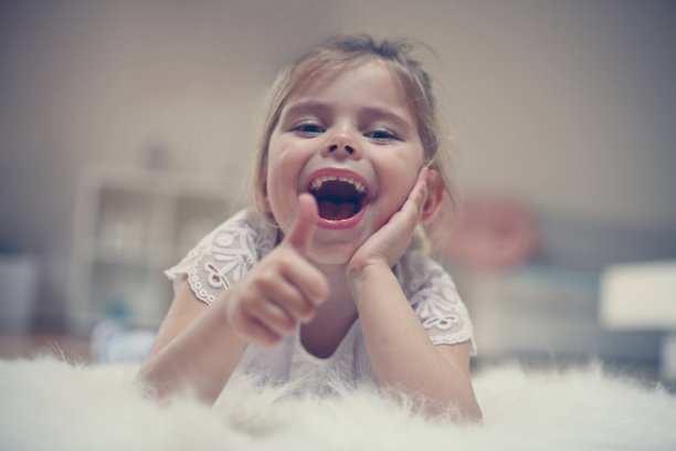 小女孩躺在地板上。图片下载