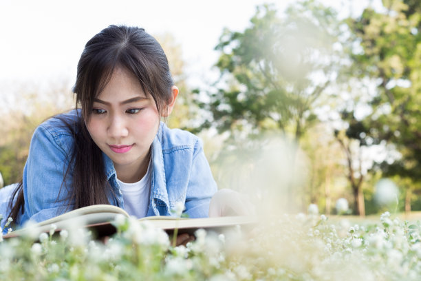 亚洲女孩躺着看书图片下载