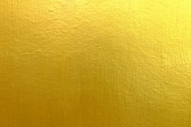 混凝土墙面纹理背景上的金色涂料。图片下载
