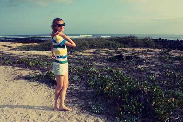 一个女人在加拉帕戈斯群岛的海滩上散步图片下载