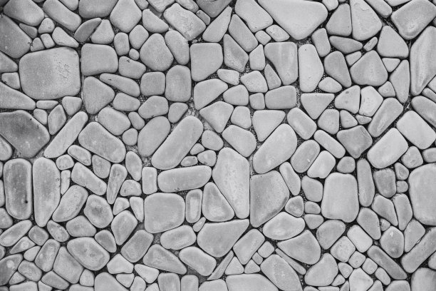 圆形弯曲岩石墙背景。石材装饰墙纸瓷砖黑白纹理图案。图片下载