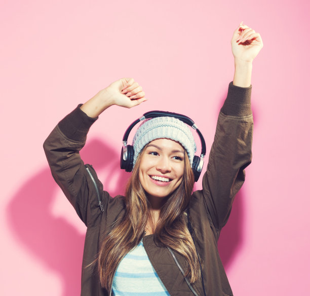 快乐的年轻女子戴着耳机图片下载