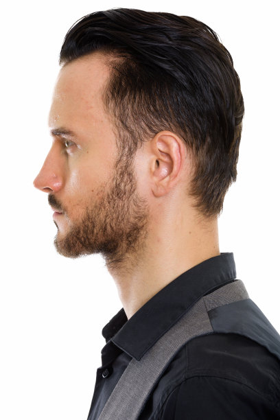 年轻英俊的商人穿着背心的脸的侧面视图图片下载