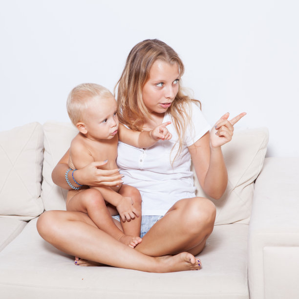 姐姐和她的弟弟坐在沙发上图片下载