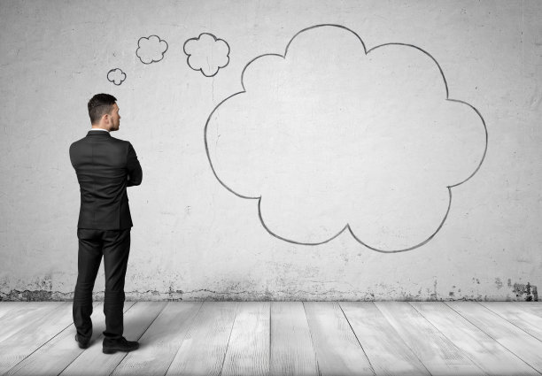 商人和思想云在混凝土墙的背景图片下载
