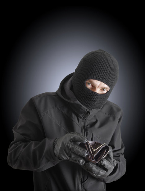 带着偷来的皮包的蒙面罪犯图片下载