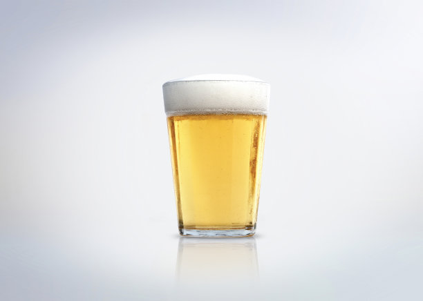 一杯有泡沫的淡啤酒。图片下载