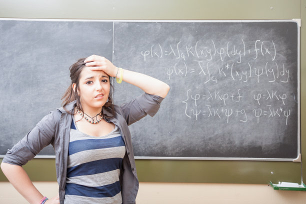 一个十几岁的学生在黑板前图片下载