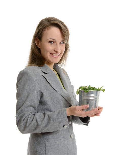 美丽的女商人捧着一盆绿色植物图片下载