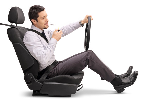 商人一边开车一边点燃香烟图片下载