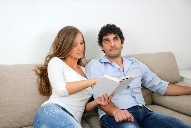 女人向丈夫展示书中有趣的部分图片下载