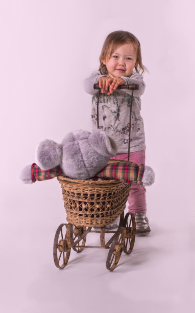 可爱的小女孩玩玩具婴儿车和老鼠图片下载