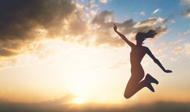 日落时分，年轻女子在户外跳跃图片下载
