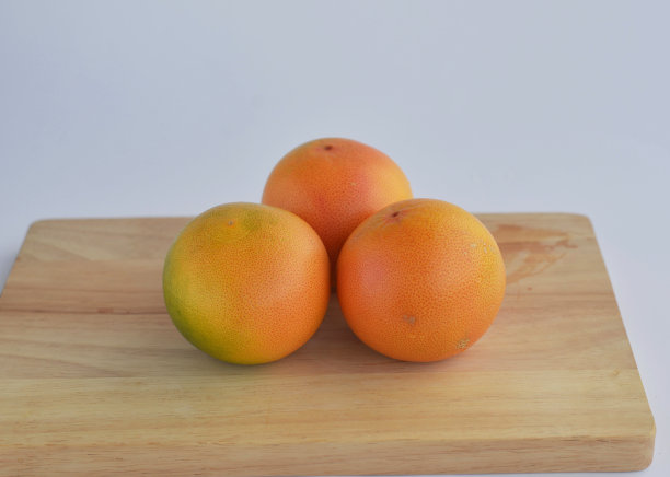 三个葡萄柚，隔离在桌子上图片下载