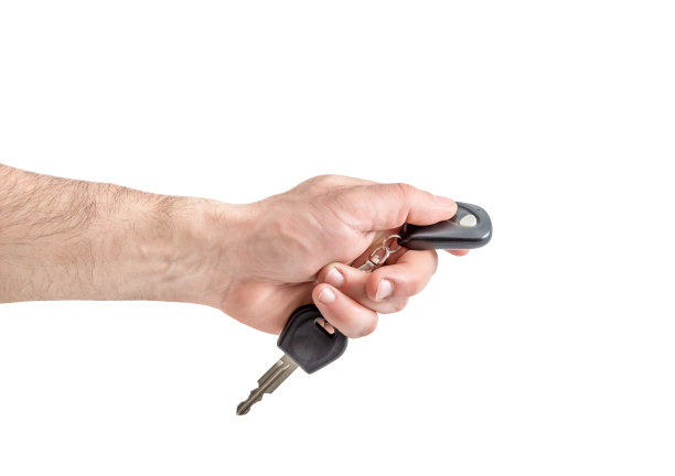 男用遥控器握着车钥匙。孤立在白色的。图片下载