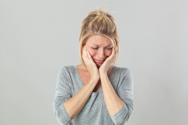 伤心欲绝的年轻金发女子哭泣表达震惊下的感受图片下载