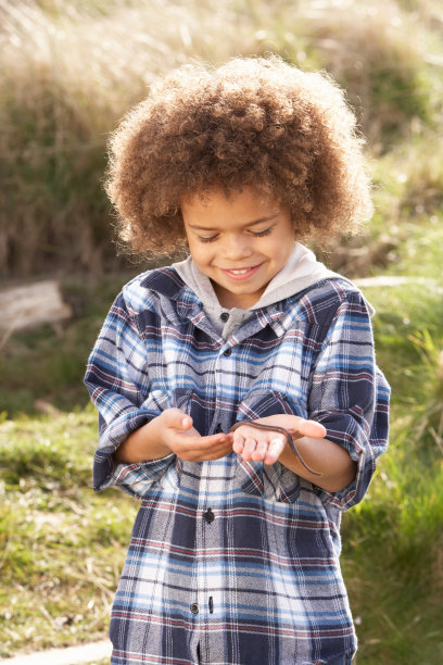 小男孩在户外抱着虫子图片下载