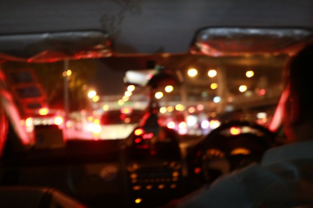 夜间的道路景观从车内自然光街道和其他车辆是运动模糊与bokhen使用慢速快门。图片下载