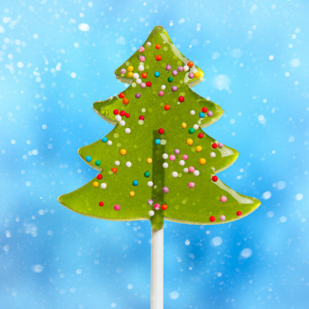 蓝色背景上的甜美圣诞树。图片下载