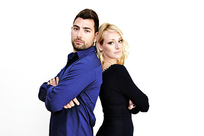 一对年轻的夫妇站在一起，背对着白色的东西。图片下载