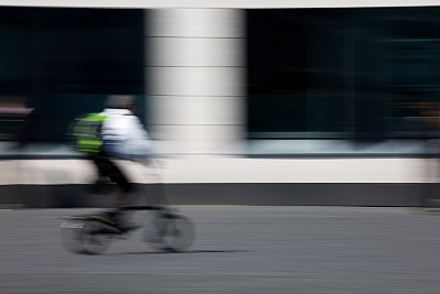 骑着自行车穿过城市的人图片下载