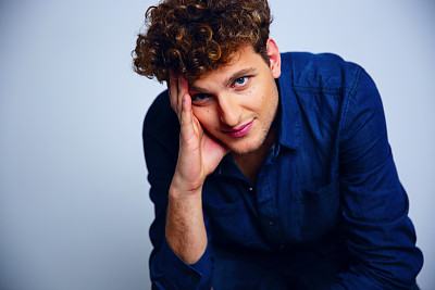 英俊的卷发沉思的男人图片下载