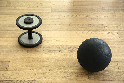 球和哑铃放在木地板上图片下载