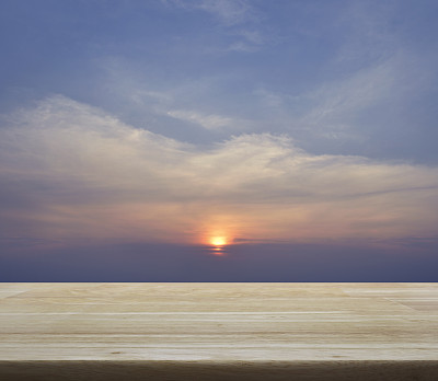 空木桌与日落的天空和云彩图片下载