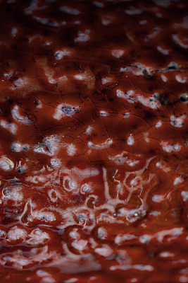 手工陶器的红色纹理。红色陶瓷背景。抽象的纹理和背景为设计师。红色陶器表面的宏观视图。手工制作的工艺品。图片下载