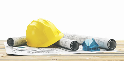 带着新房子设计图的黄色头盔图片下载