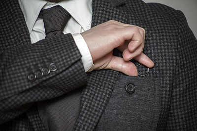 男人把一枚订婚戒指藏在口袋里图片下载