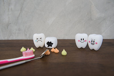 木制的桌子上放着可爱的玩具牙齿和五颜六色的糖果图片下载