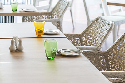 木质餐桌与彩色餐具在餐厅内部用餐图片下载