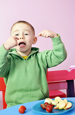 小男孩在吃健康的零食图片下载