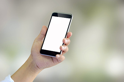 模糊背景下的男子使用智能手机图片下载