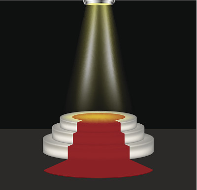 灯光照在铺着红地毯的空旷讲台上图片下载