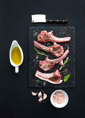 生的羊排。羊排配大蒜，迷迭香和图片下载