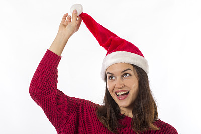 拿着圣诞老人帽上的球图片下载