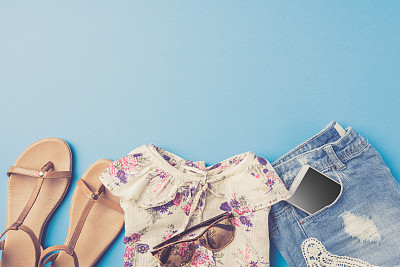 蓝色背景的女人夏装。图片下载