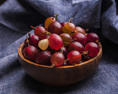 木碗里装着新鲜的鹅莓图片下载