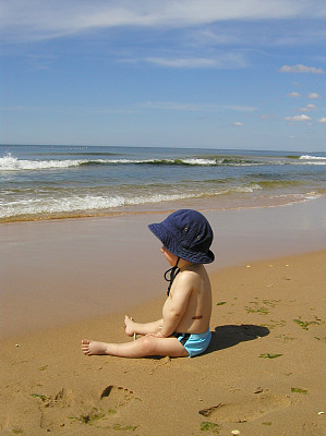 宝贝在沙滩上，看着大海图片下载