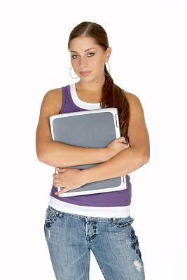 穿着紫色坦克拥抱笔记本电脑的年轻女人图片下载