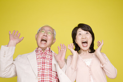 一对老夫妇高举着手臂，令人惊叹图片下载