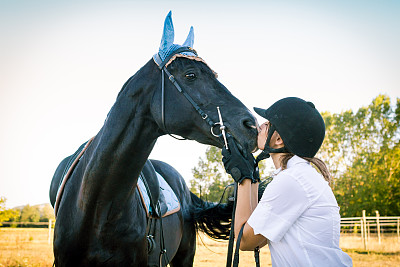 骑师女孩在乡下亲吻她的黑马图片下载