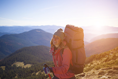 背着背包的女孩爬上了山。图片下载