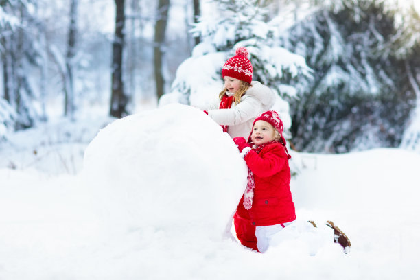 孩子们堆雪人，雪地里的儿童，冬季乐趣素材图片